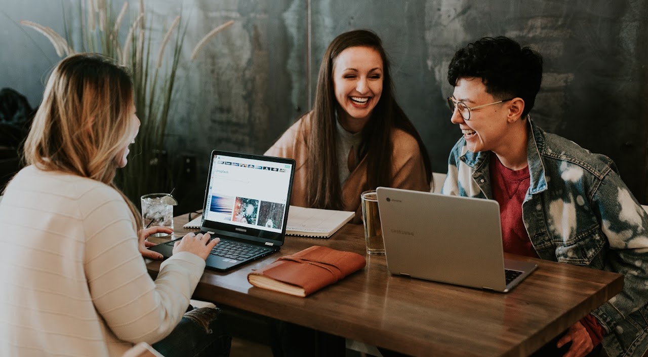 People collaborating around laptops